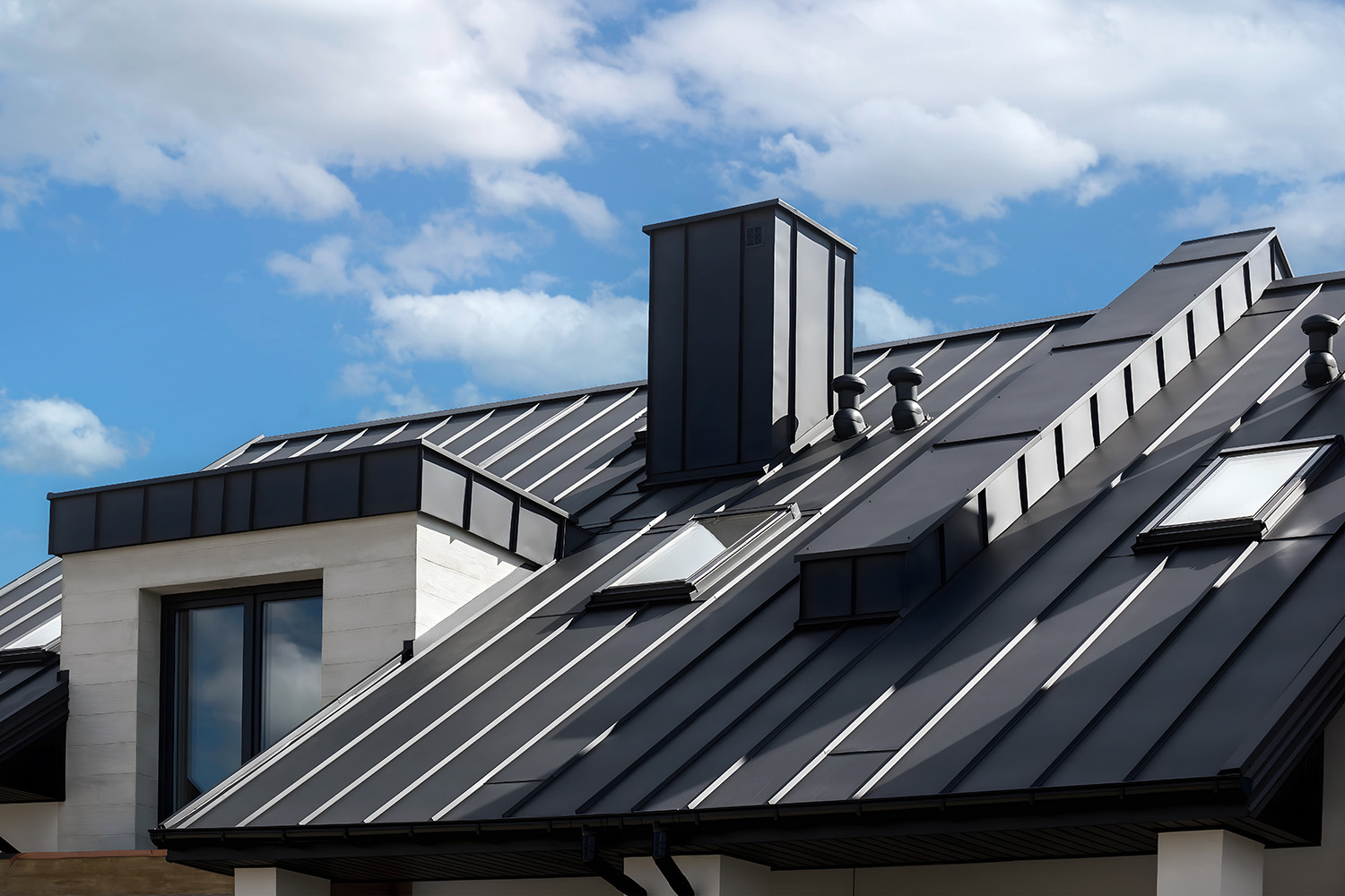 Close-up house retro roof panel with standing seam and fasteners. Modern galvanized steel roofing sheet with ribs. Classic style black metal panel with rebate joint. Falz roofing. Building’s covering