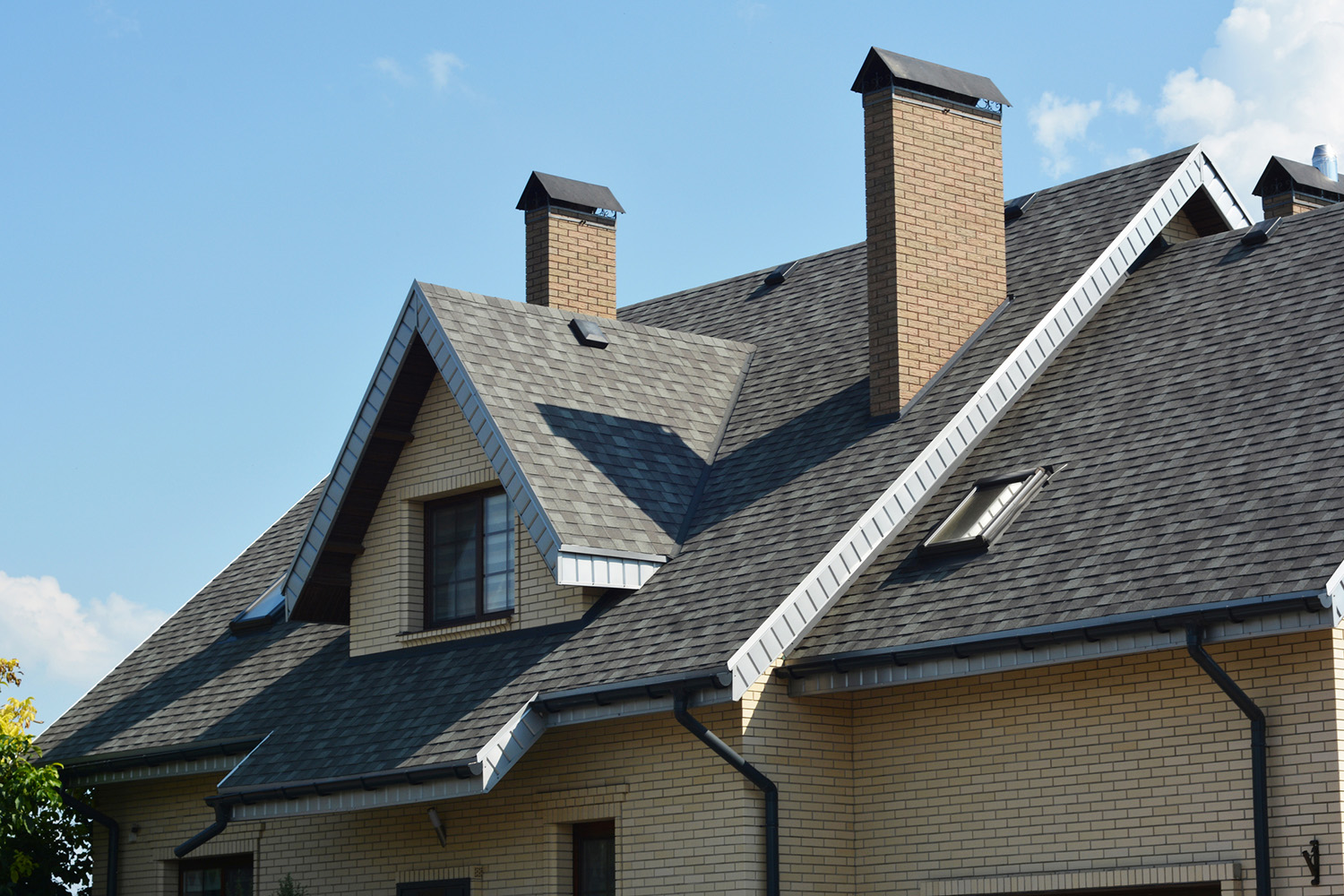 House asphalt shingles rooftop with dormer window, attic skylights, rain gutter, soffits, roof vents.